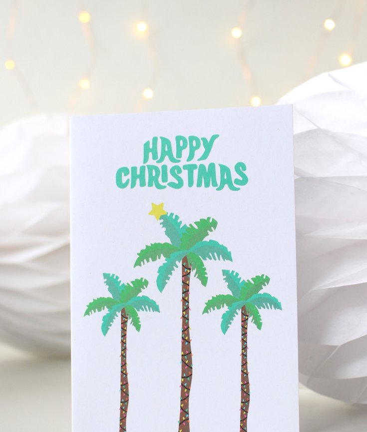 christmas card with palm trees in a globe by Tihara Smith